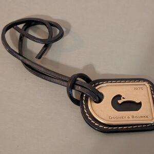 Dooney & Bourke Black and Gold Logo Bag Tag